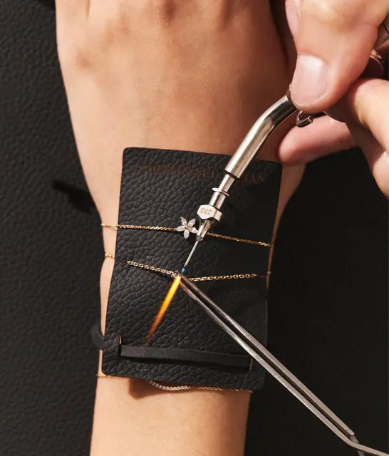 Sarah & Sebastian permanent bracelet being flame-soldered onto a wrist