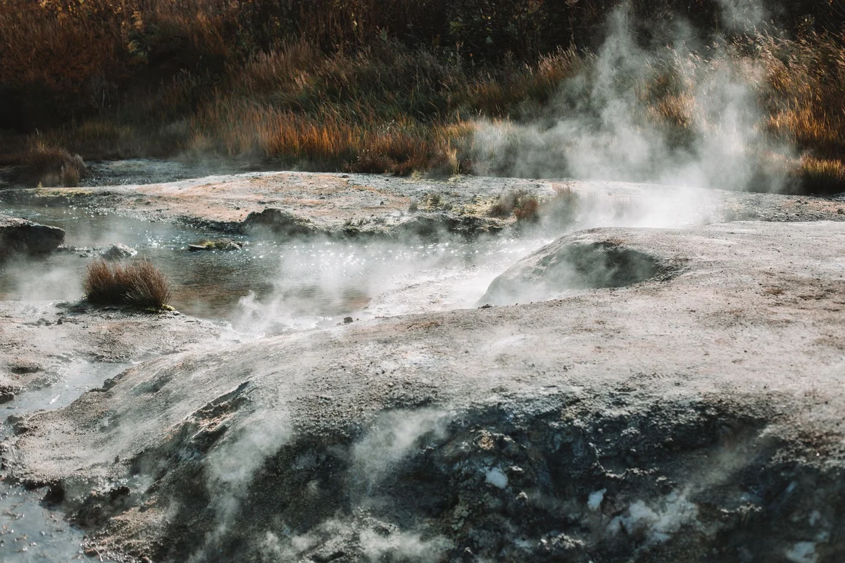 Hot springs steam rising in a mountain valley