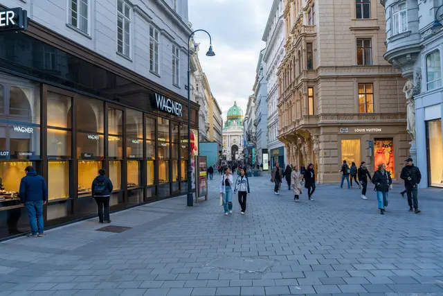 People walking a fashion shopping street in a historic city district