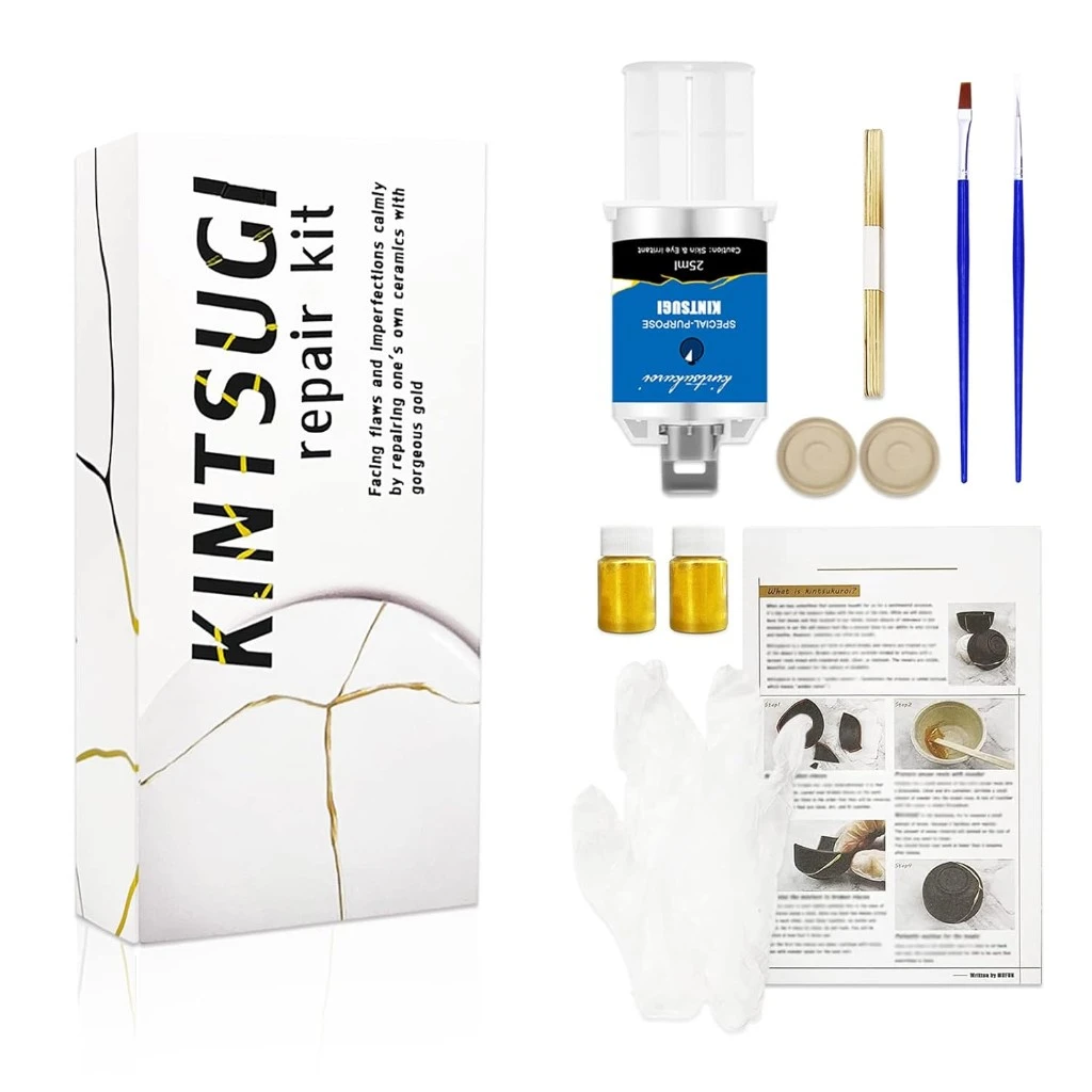 Kintsugi repair kit with gold powder, epoxy, and brushes