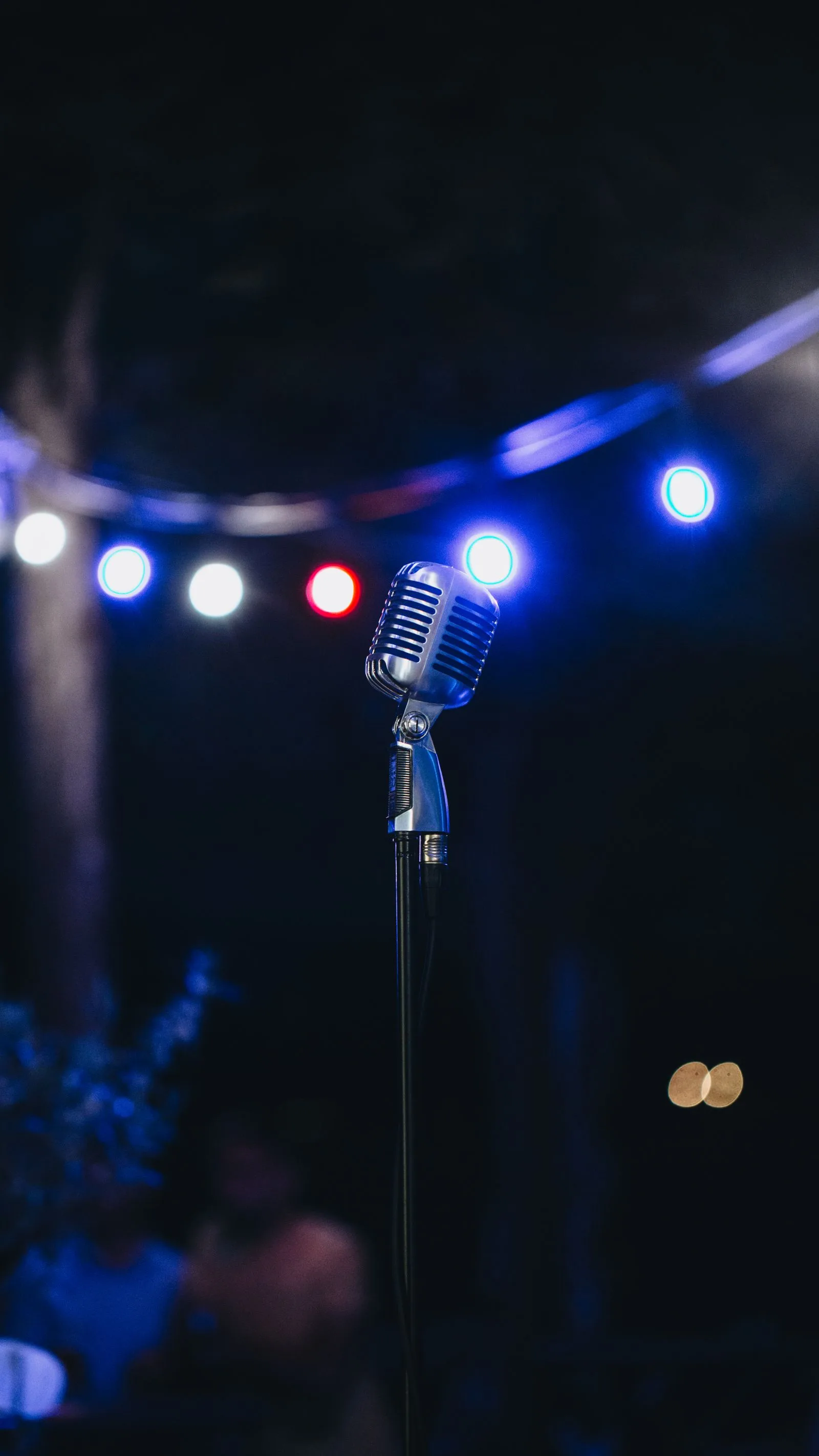 Microphone on a stage with lights for a comedy night voucher