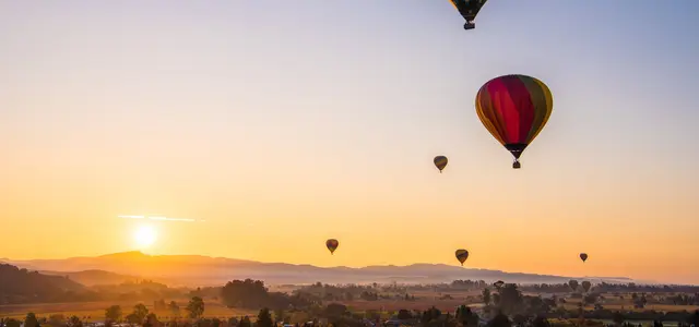 Hot air balloon sunrise over wine country